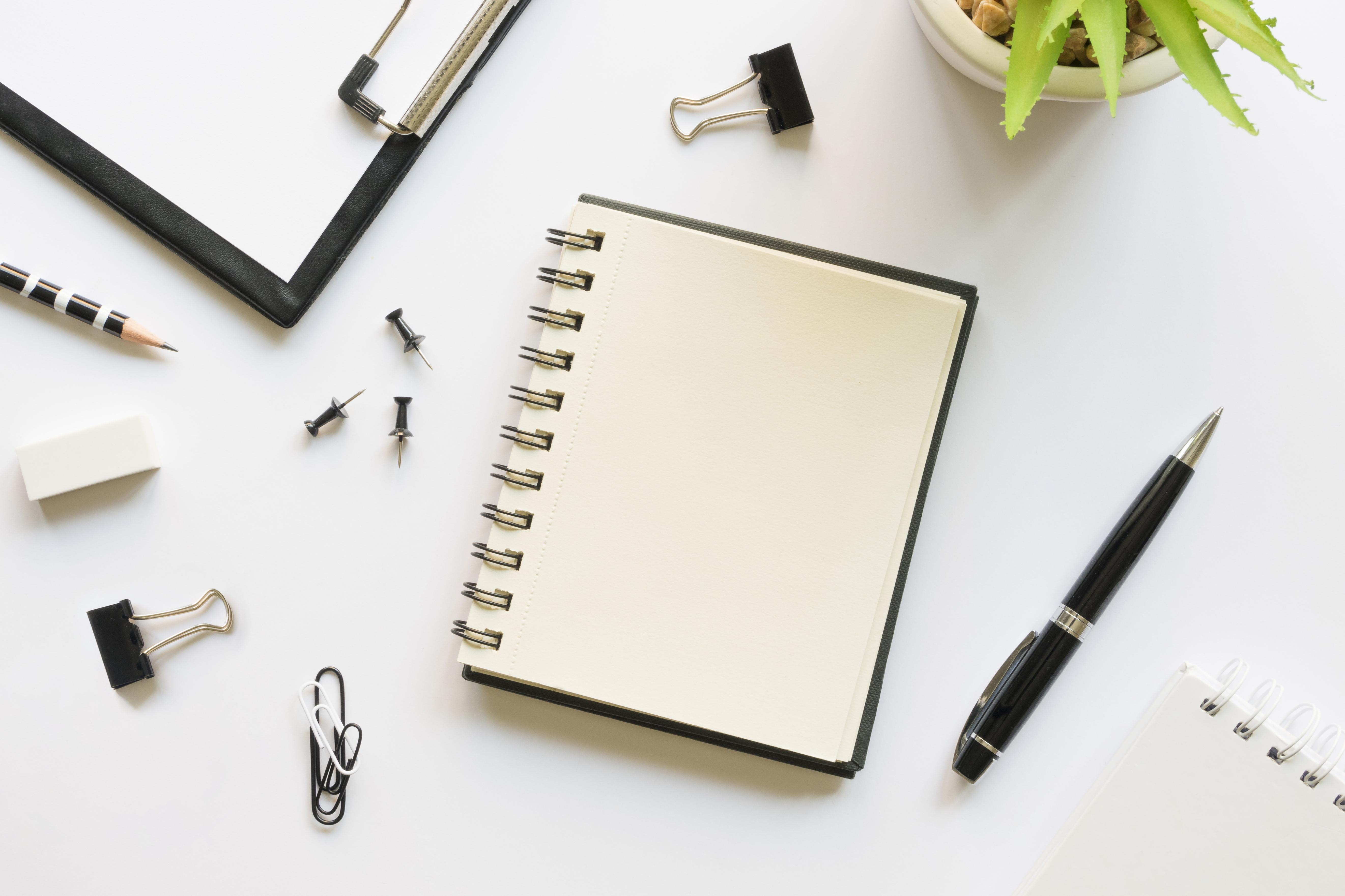 top-view-office-stationery-with-notebook-pins